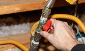 plumber hand close up checking gas lines at house elk river mn