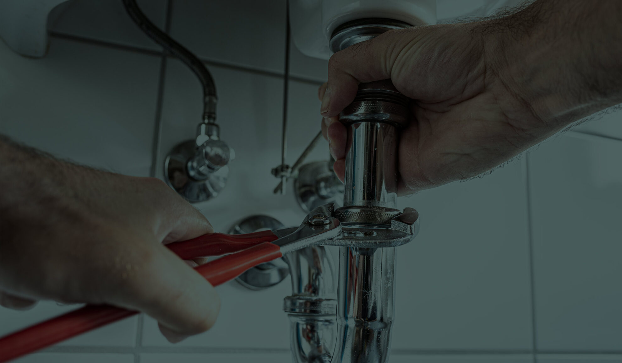 plumber hands close up repairing bathroom pipes with wrench elk river mn
